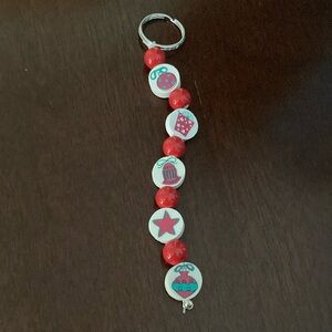 A clay and ceramic Christmas beaded keychain